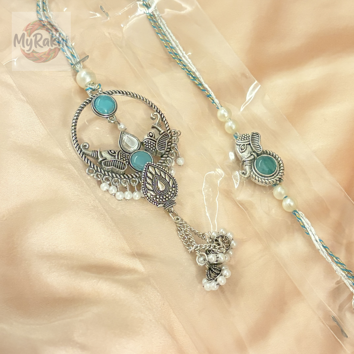 An elegant rakhi adorned with traditional stone embellishments and metallic accents, offering a classic and sophisticated appeal.
