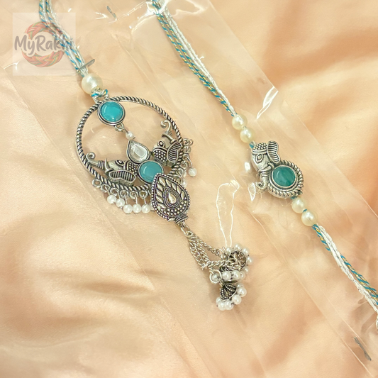 An elegant rakhi adorned with traditional stone embellishments and metallic accents, offering a classic and sophisticated appeal.