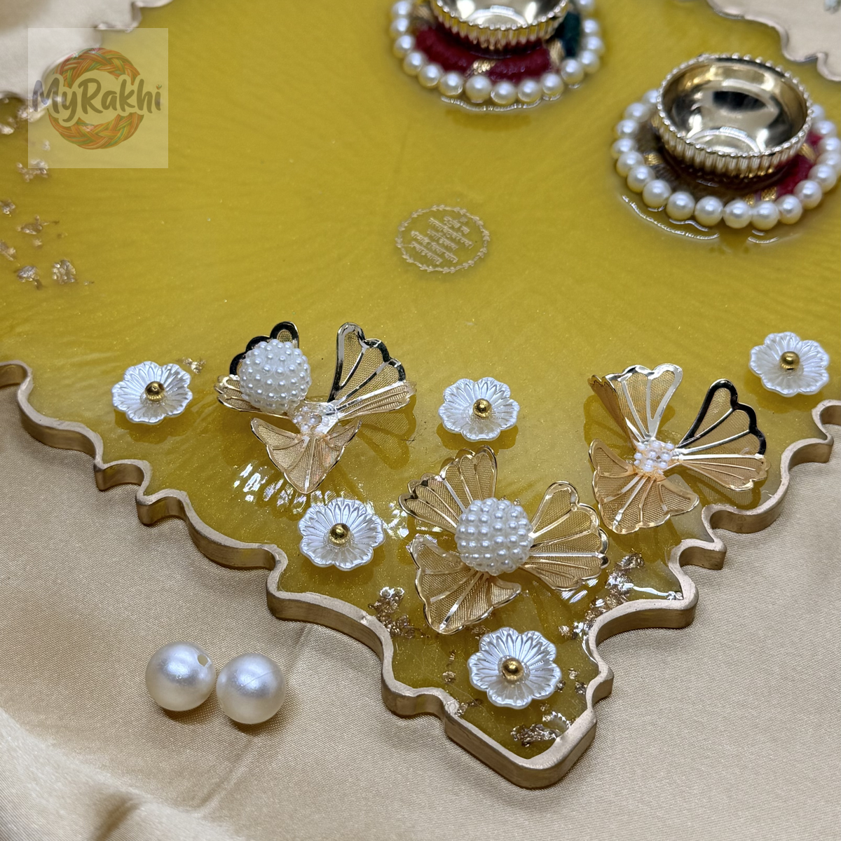 A large, 8-inch premium yellow resin thali featuring gold flake detailing, dual kumkum holders, and elaborate 3D floral pearl embellishments.