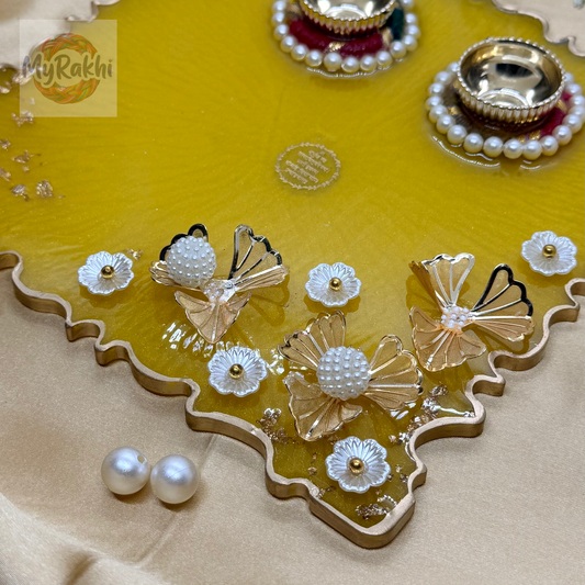 A large, 8-inch premium yellow resin thali featuring gold flake detailing, dual kumkum holders, and elaborate 3D floral pearl embellishments.