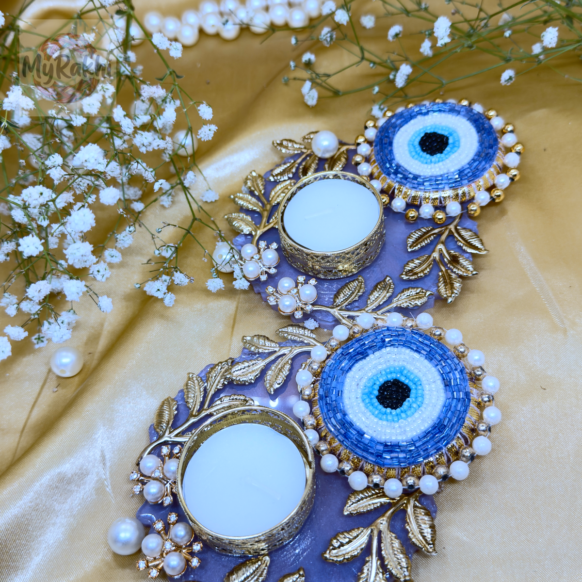 A unique set of purple resin tealight holders featuring handcrafted beaded evil eye charms and golden leaf filigree.