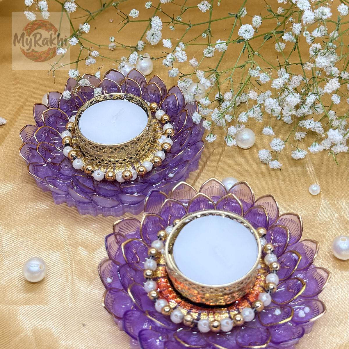 Stunning tealight holders designed with layered purple resin petals, a gold-filigree center, and a pearl-studded inner rim for a sophisticated glow.
