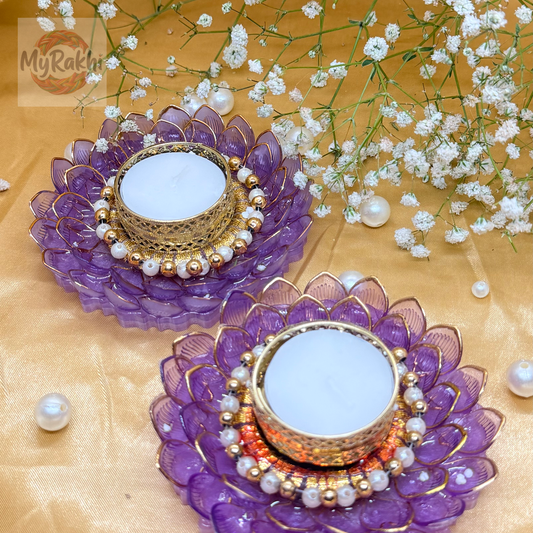 Stunning tealight holders designed with layered purple resin petals, a gold-filigree center, and a pearl-studded inner rim for a sophisticated glow.